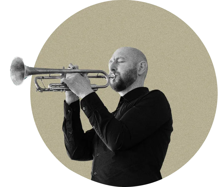 An image of a man playing a trumpet